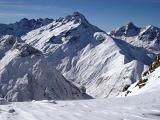 Beautiful Spot of Snow Covered High Mountains During Winter Season on Light Blue Sky Background.